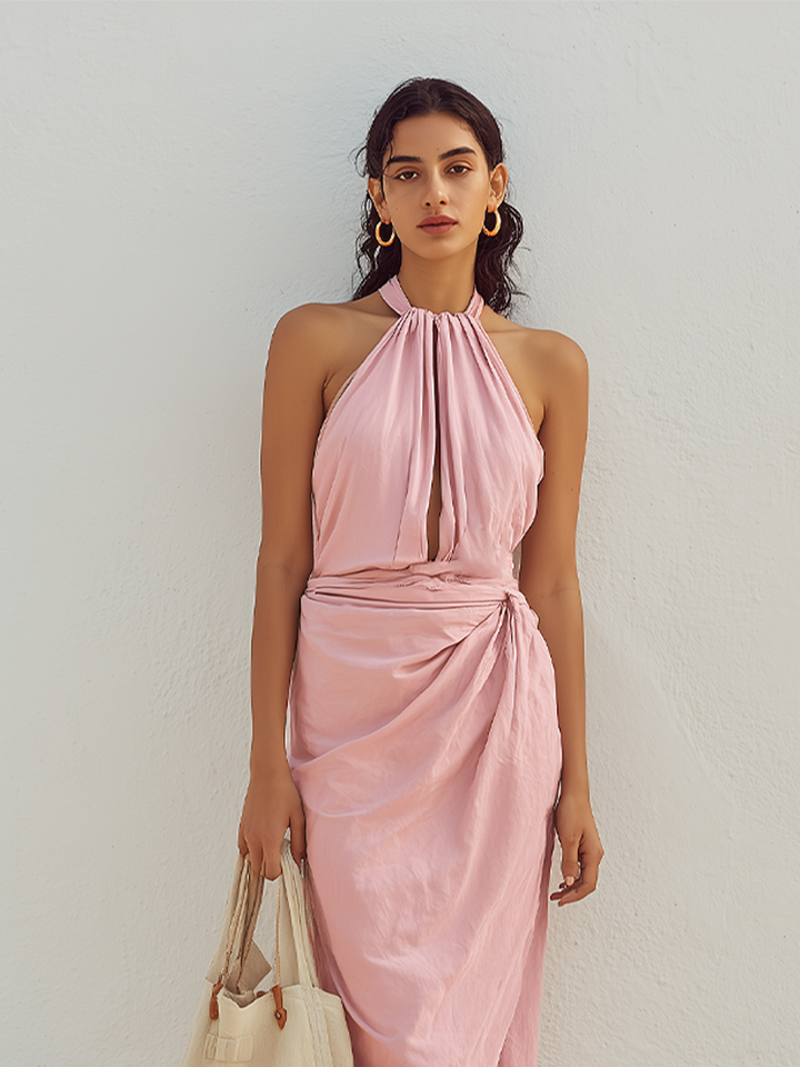 Close-up of women's pink halter neck midi dress showing gathered neckline and torso.