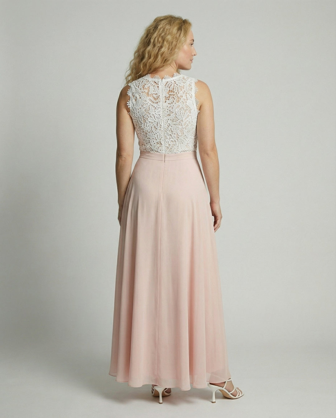 Women's white floral lace sleeveless maxi dress with pink skirt, back view with zipper.