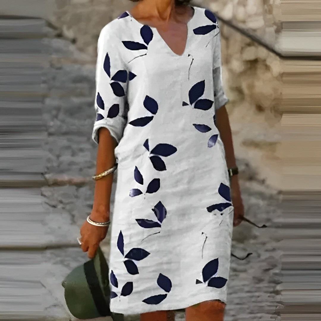 Women white printed V neck mini dress with short sleeves and leaf pattern front view