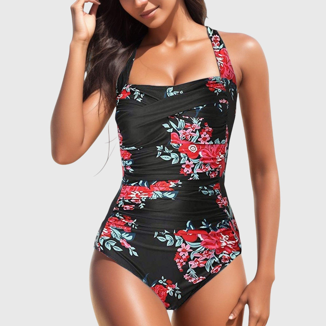 Black one-piece swimsuit with red floral design and crossover ruched bodice