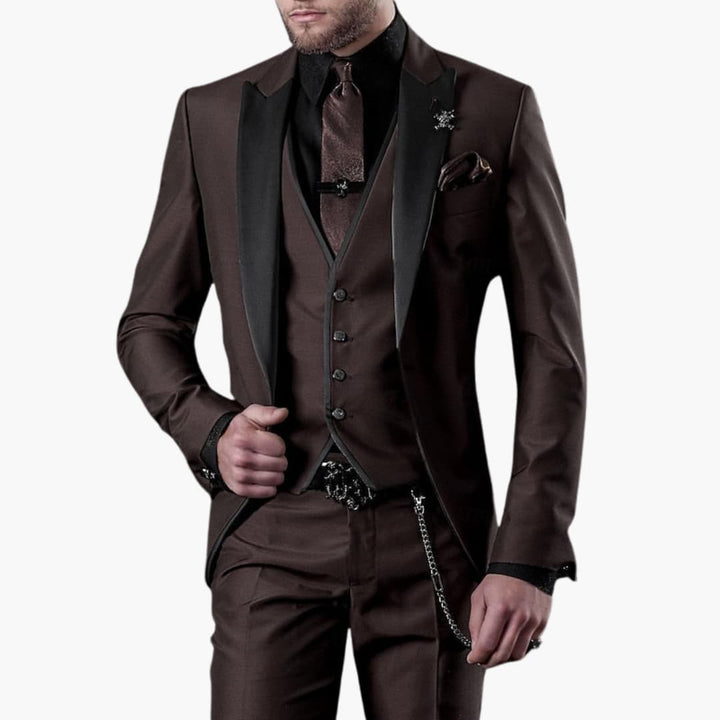 Brown three-piece suit with notch lapel blazer, vest, and matching trousers with chain detail