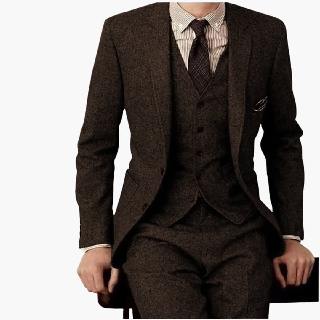 Men's brown tweed formal wedding three-piece suit with fitted tailored pants and notch lapel blazer detail