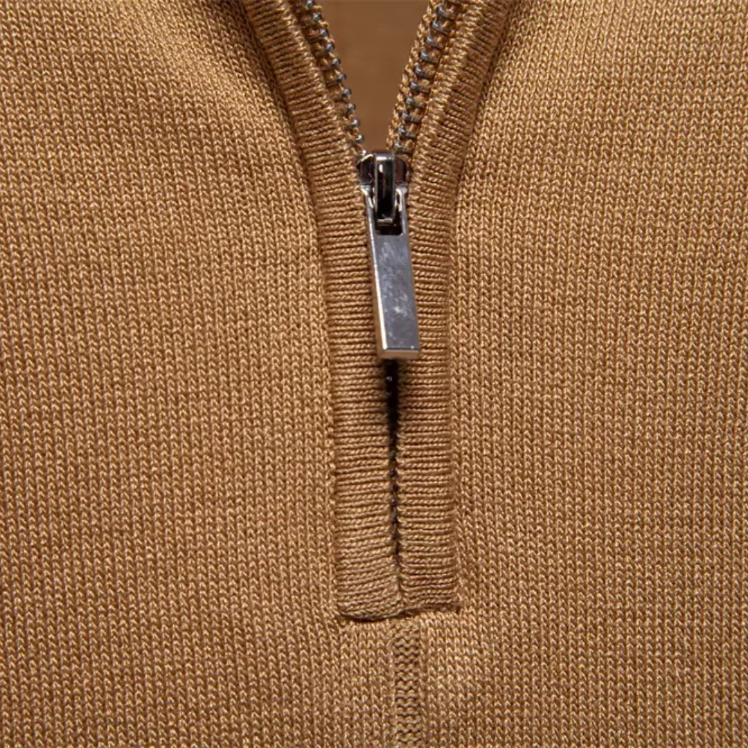 Close-up of silver quarter zip closure on camel knit polo shirt