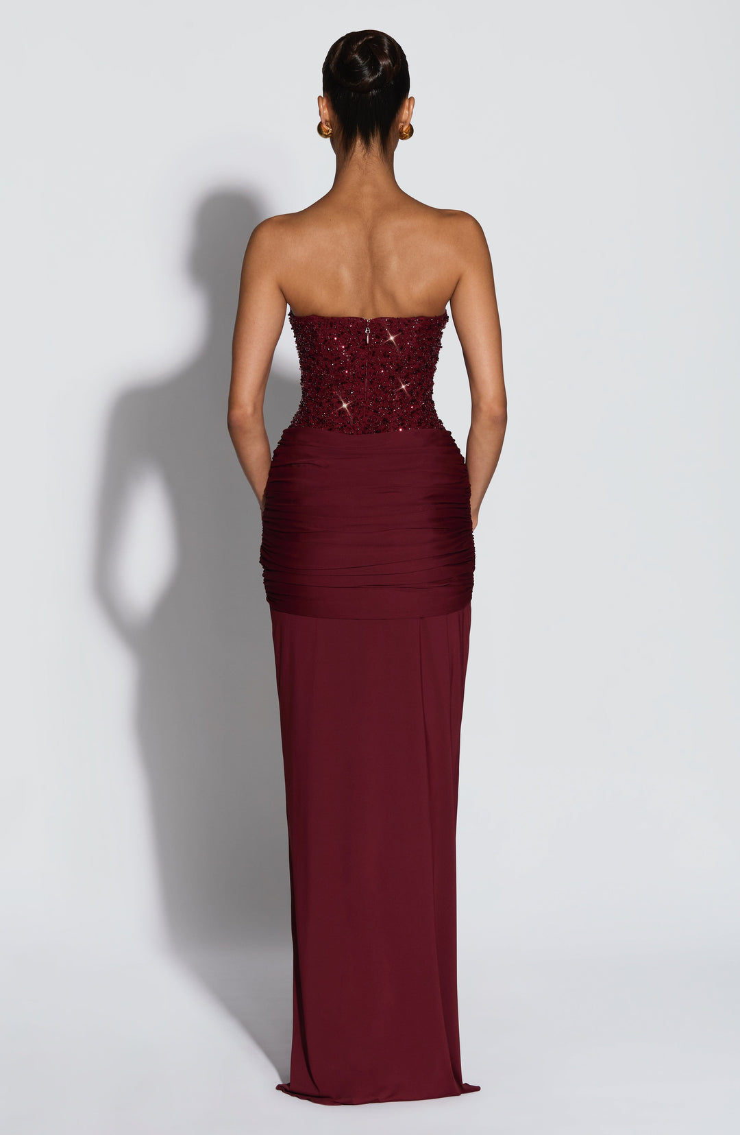 Women burgundy strapless sequin maxi dress showcasing back zipper closure and plain back skirt