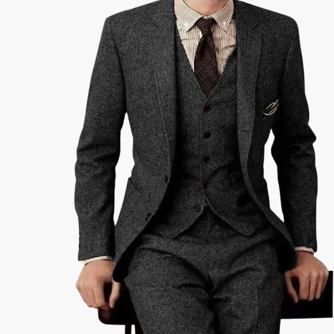Men's charcoal gray herringbone formal wedding suit with single-breasted blazer and coordinated vest, front view