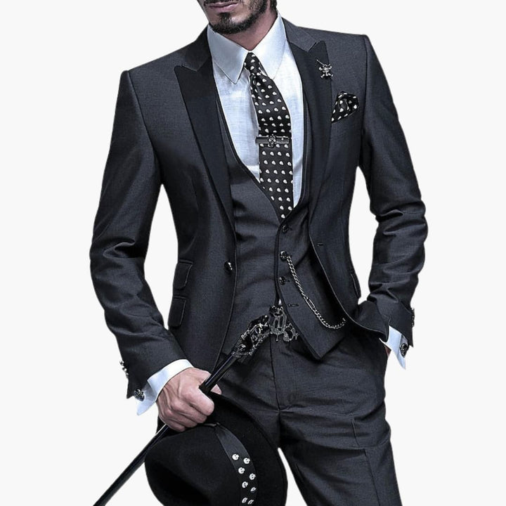 Charcoal gray three-piece suit with white dress shirt and polka dot tie detail