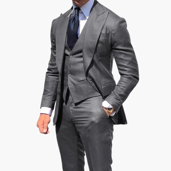 Charcoal gray three-piece suit with tailored blazer and vest front
