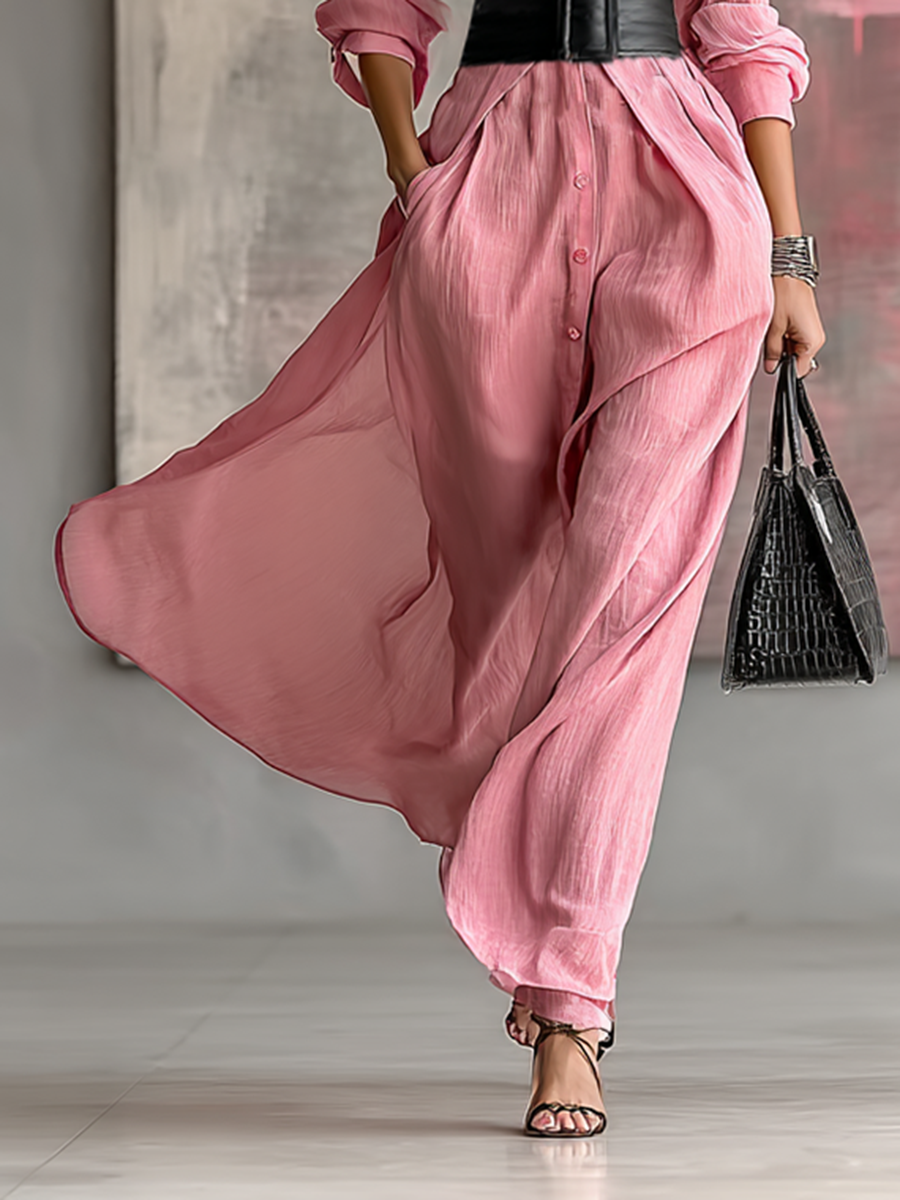 Lower section of women's pink maxi dress, showing flowing skirt and visible side pocket detail
