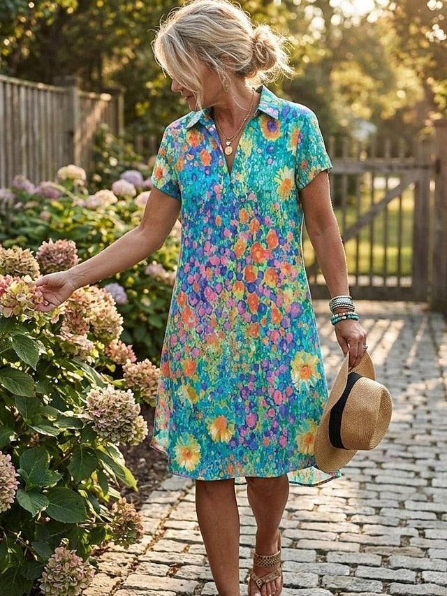 Women's floral short sleeve mini dress with polo collar, front view in outdoor garden setting