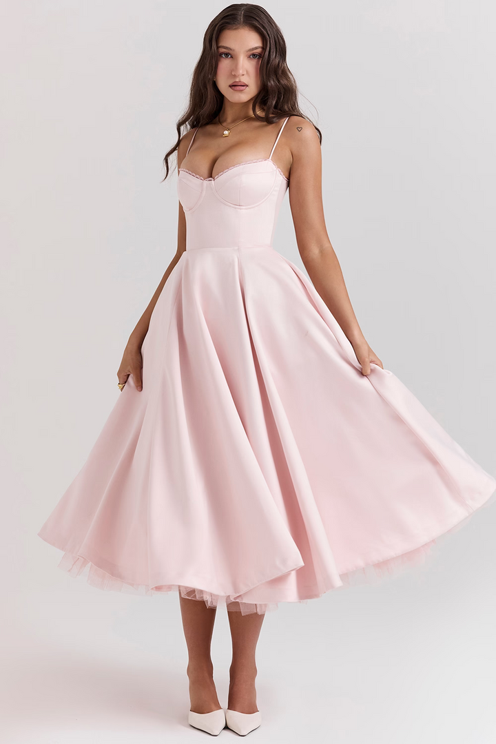 Women light pink bustier midi dress with voluminous skirt, shown in motion, front view.