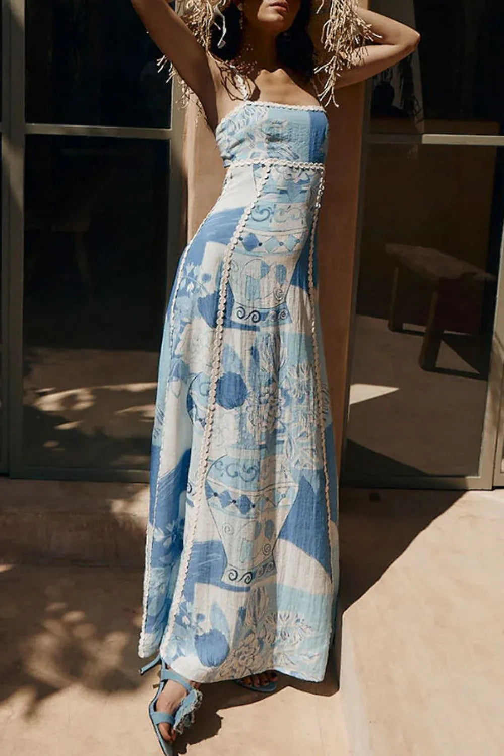Women blue and white printed maxi dress with square neckline and flowing skirt, full view.