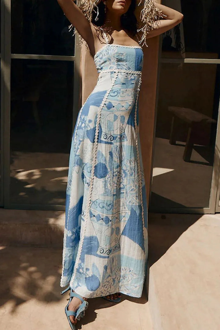 Women blue and white printed maxi dress with square neckline and flowing skirt, full view.