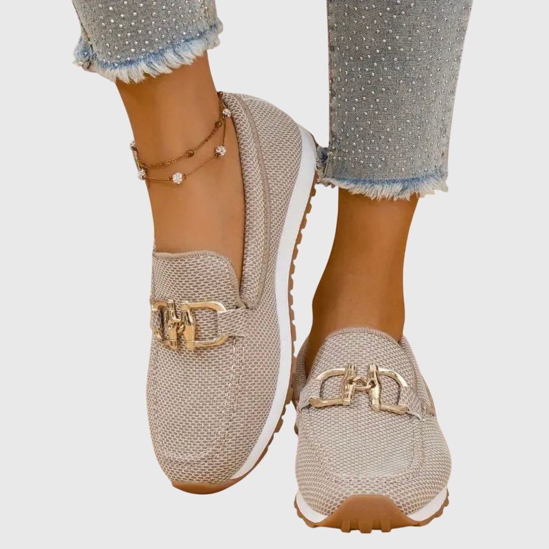 Women beige slip on buckle loafers with mesh upper and white midsole, overhead view