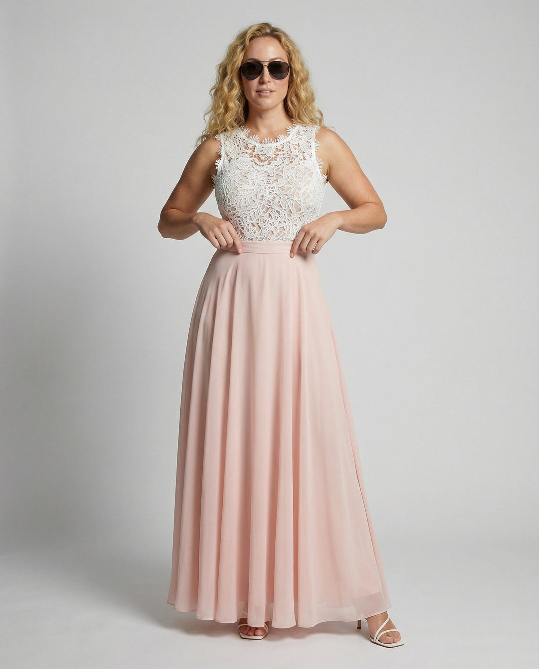 Women's white floral lace sleeveless maxi dress with pink flowing skirt, front view.