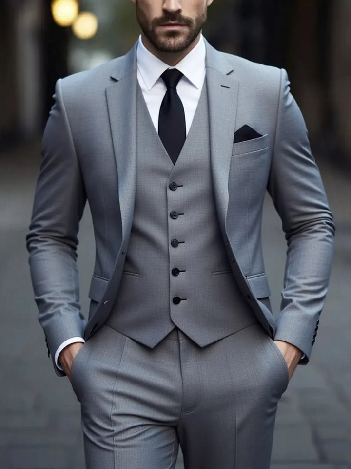 Gray double-breasted three-piece suit with vest and pocket square detail