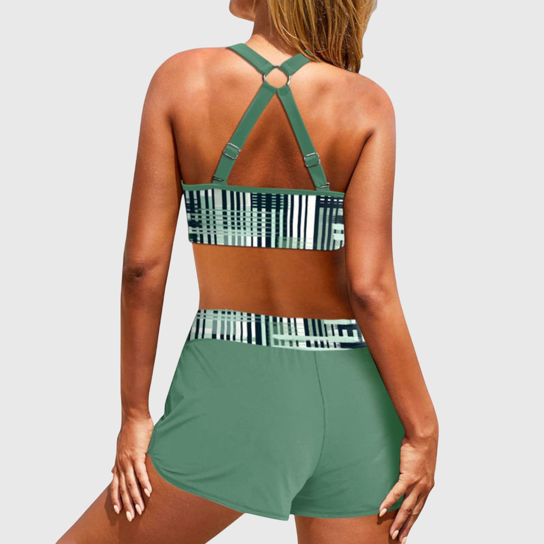 Back view of green high-waisted bikini with geometric stripe pattern and strappy design
