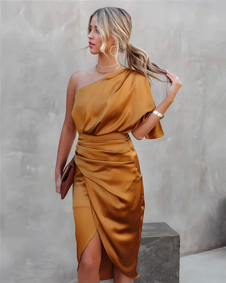 Women gold one shoulder draped midi dress with gathered waist, side profile with clutch