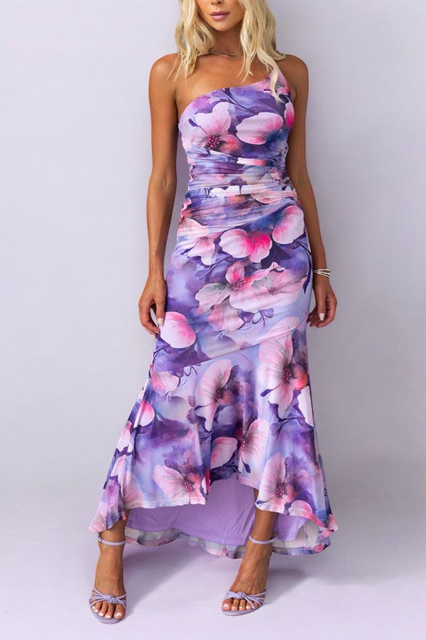Women purple floral one shoulder maxi dress, standing pose with high-low hem.