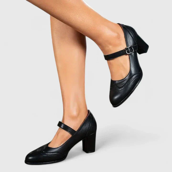Women black Mary Jane block heels showing the buckle closure and heel from a side angle.
