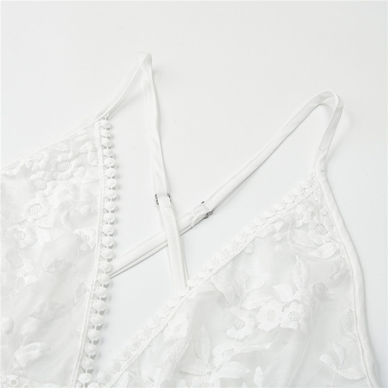 Close-up of white floral lace fabric and criss-cross straps detail