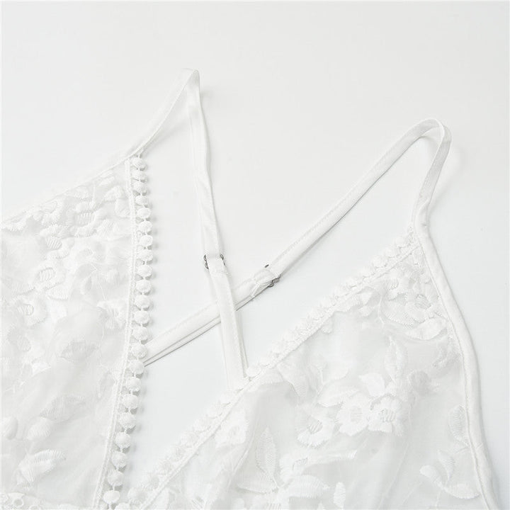 Close-up of white floral lace fabric and criss-cross straps detail