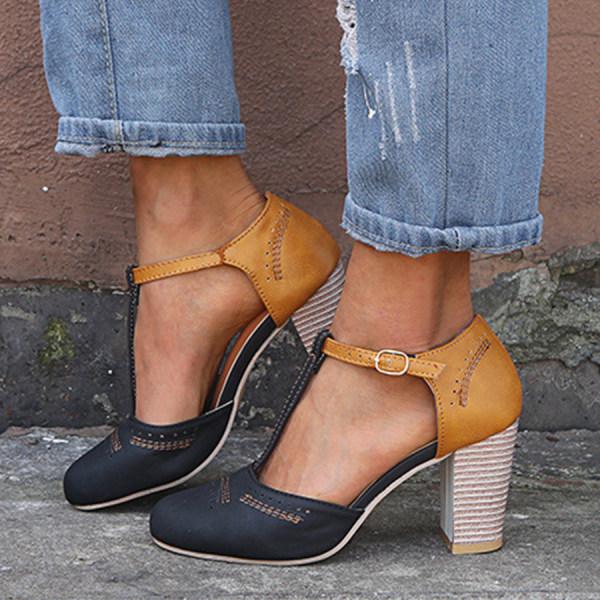 Women's black and tan T-strap block heel shoes with striped heel texture, front view.