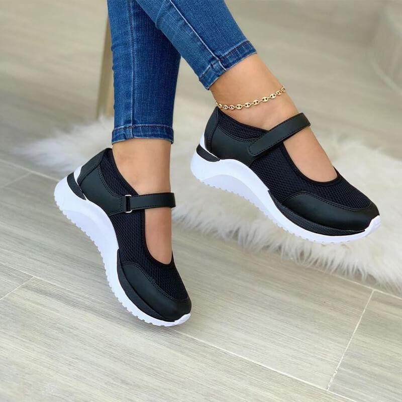Women's black mesh Mary Jane sneakers with white soles, captured from the side to show the contrasting sole design.