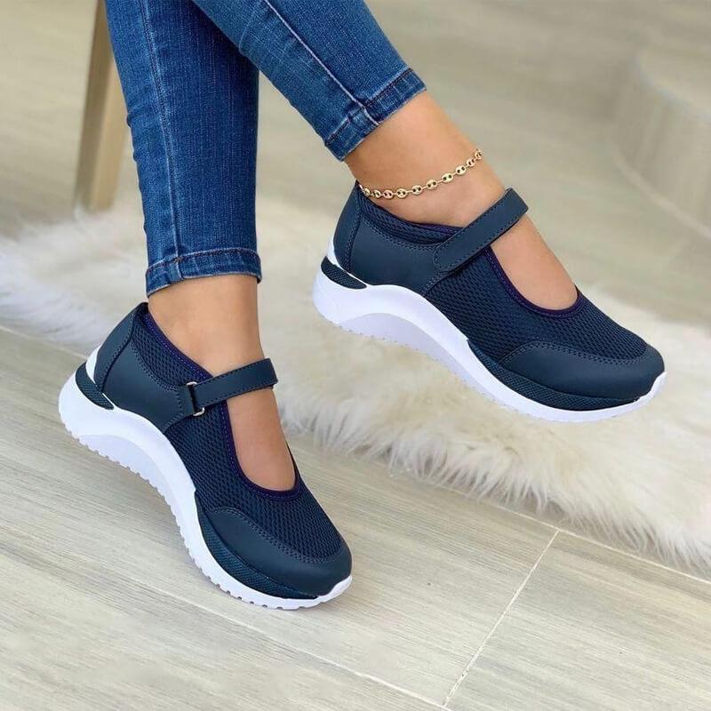 Women's navy mesh Mary Jane sneakers with white soles, highlighting the rounded toe and comfortable design.