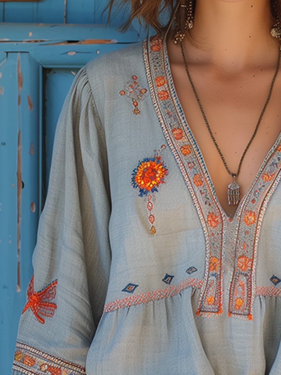 Side view of women's light blue embroidered blouse, focusing on sleeve and bodice detail