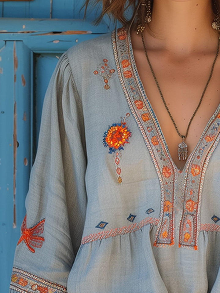 Side view of women's light blue embroidered blouse, focusing on sleeve and bodice detail