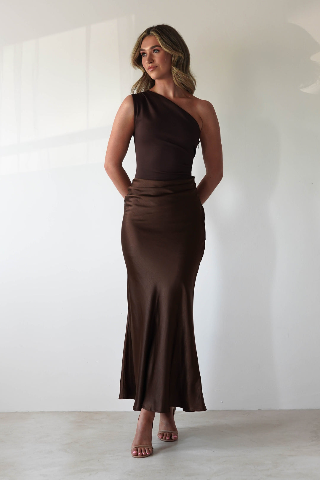 Women brown one shoulder satin maxi dress with draped bodice and flowing skirt