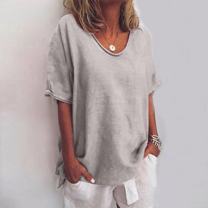 Women light gray loose fit V neck t-shirt worn with white shorts, front view.