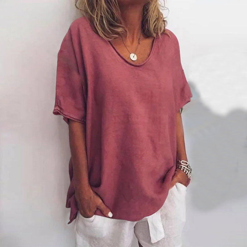 Women dark pink loose fit V neck t-shirt shown with hands in pockets, front view.
