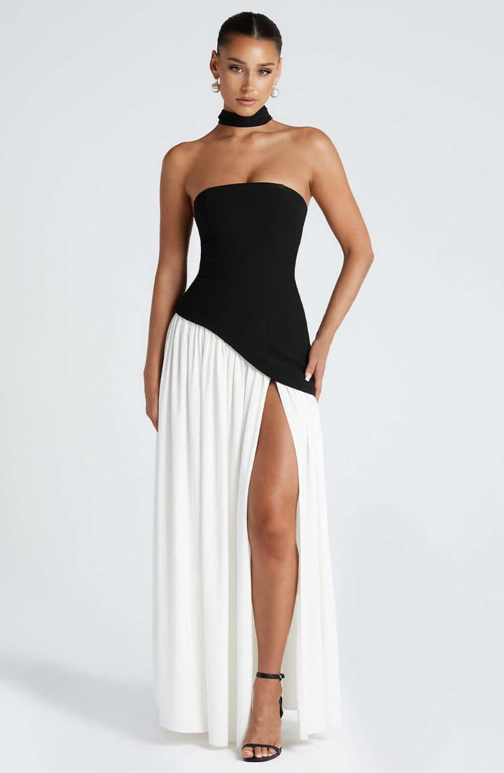 Women black and white two-tone strapless maxi dress with side split, front view.