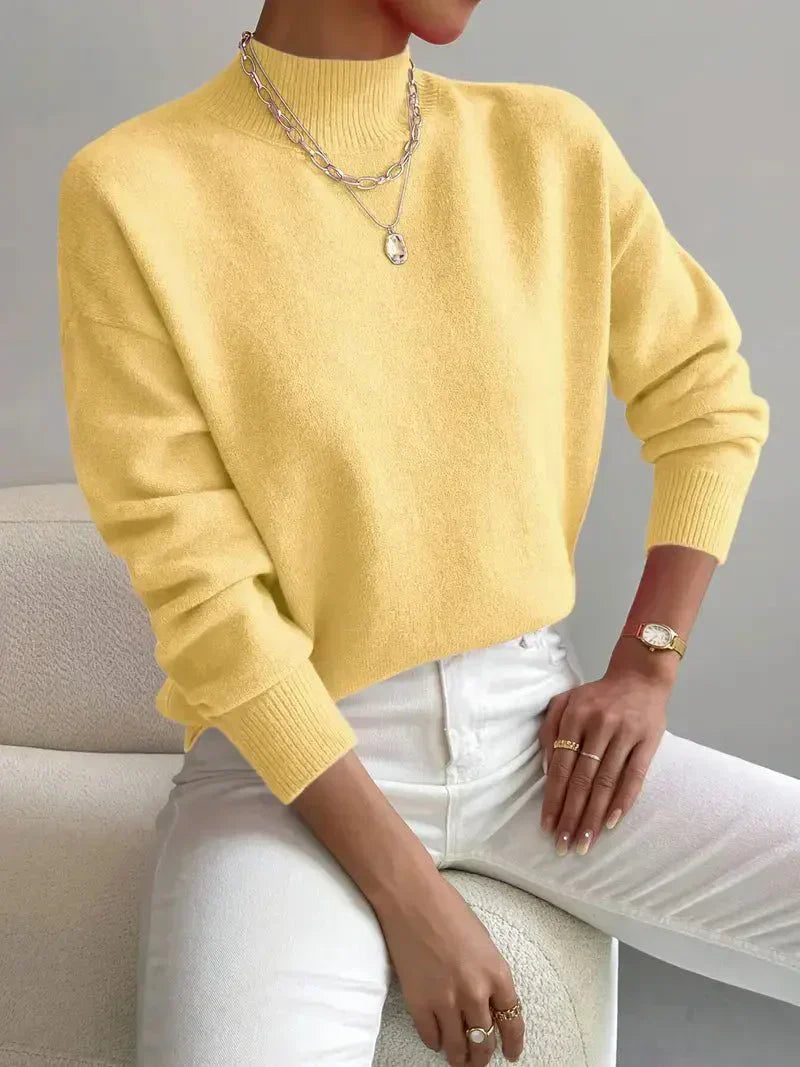 Women yellow turtleneck knit sweater with long sleeves and ribbed cuffs, product shot.