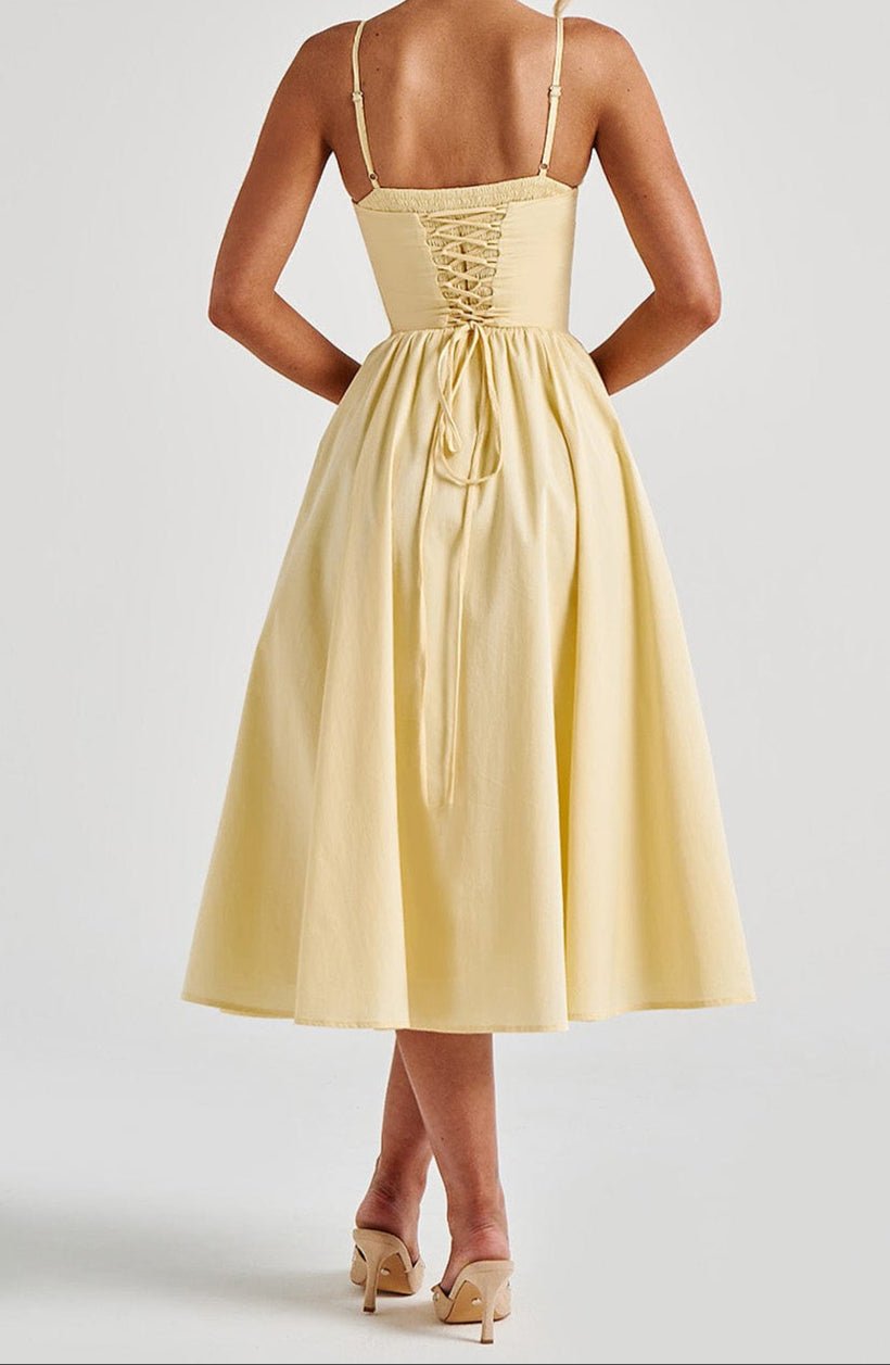 Women's light yellow midi dress with a lace-up back detail and spaghetti straps, rear view