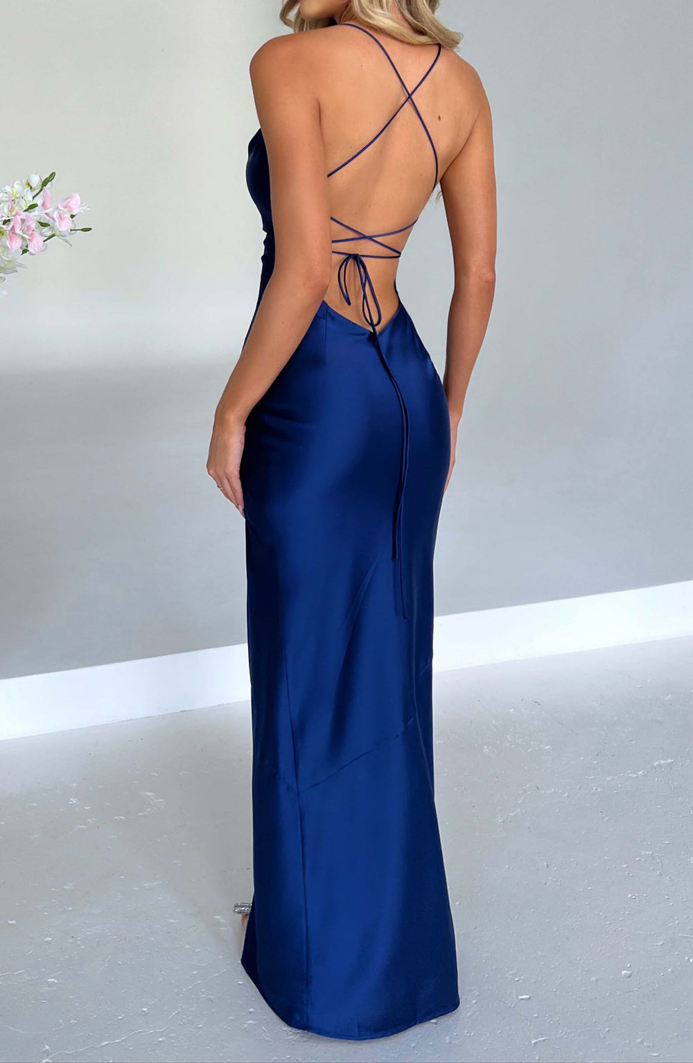 Women navy open back maxi dress with crisscross tie-up straps, back view showing details.