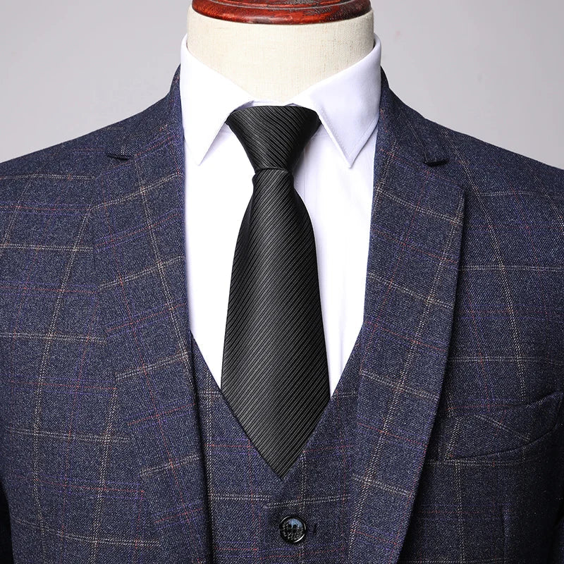 Close-up of navy plaid jacket fabric with subtle red windowpane pattern