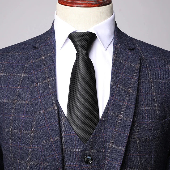 Close-up of navy plaid jacket fabric with subtle red windowpane pattern
