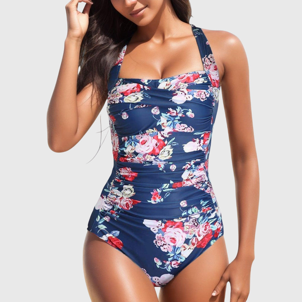Navy one-piece swimsuit with pink and red rose floral pattern and ruching