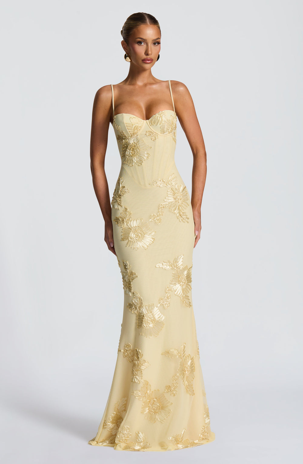 Close-up of women yellow floral embroidered maxi dress bodice with corset detail