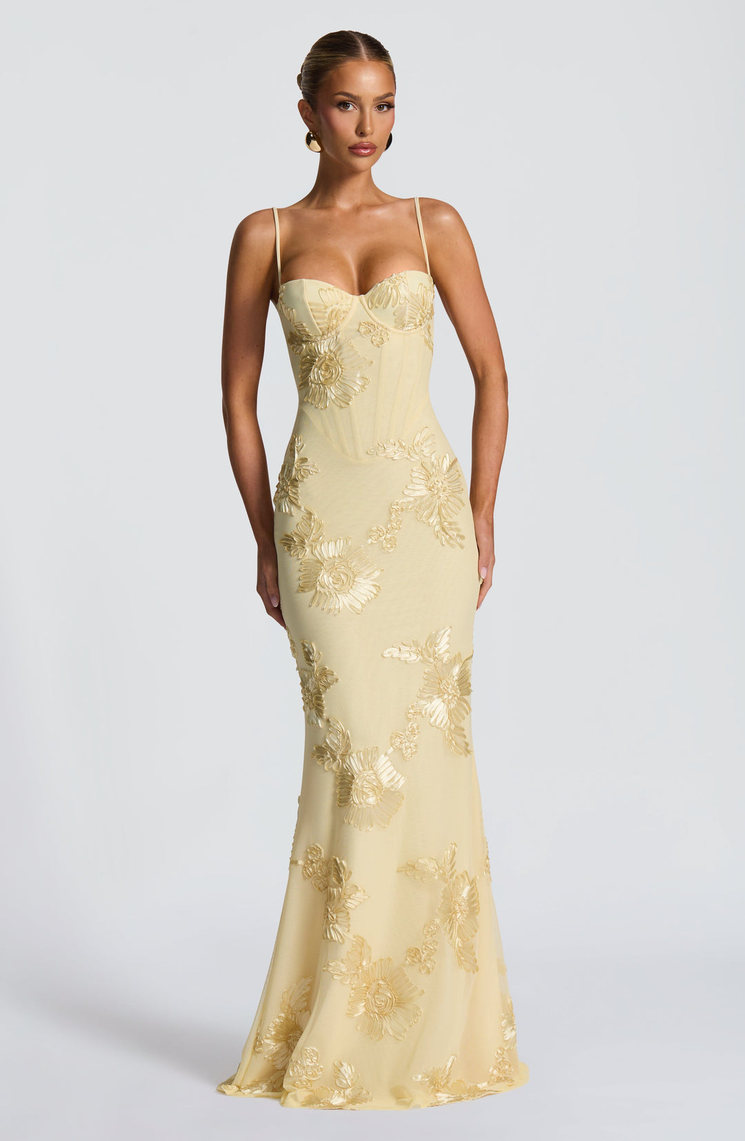 Close-up of women yellow floral embroidered maxi dress bodice with corset detail