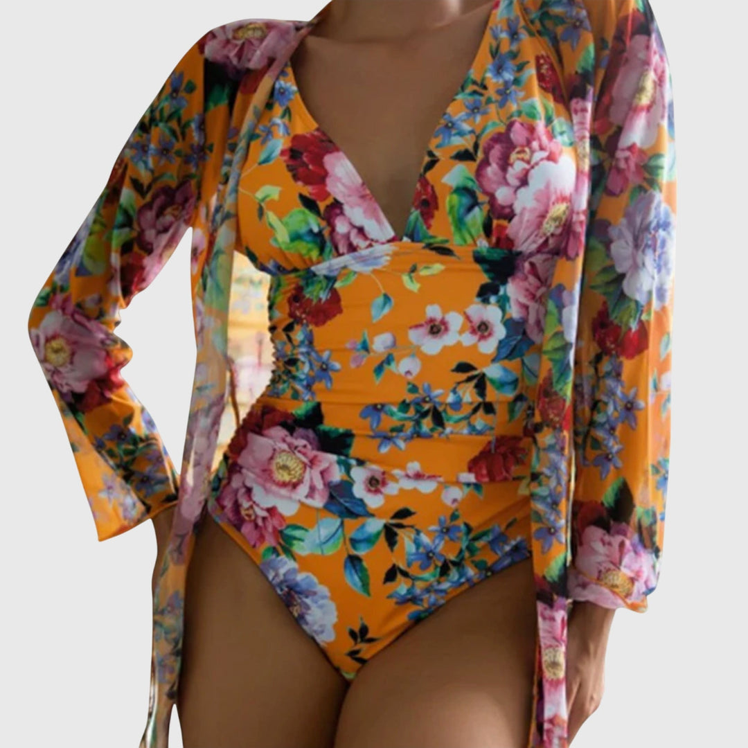 Orange floral one-piece swimsuit with long-sleeve wrap, vibrant botanical design