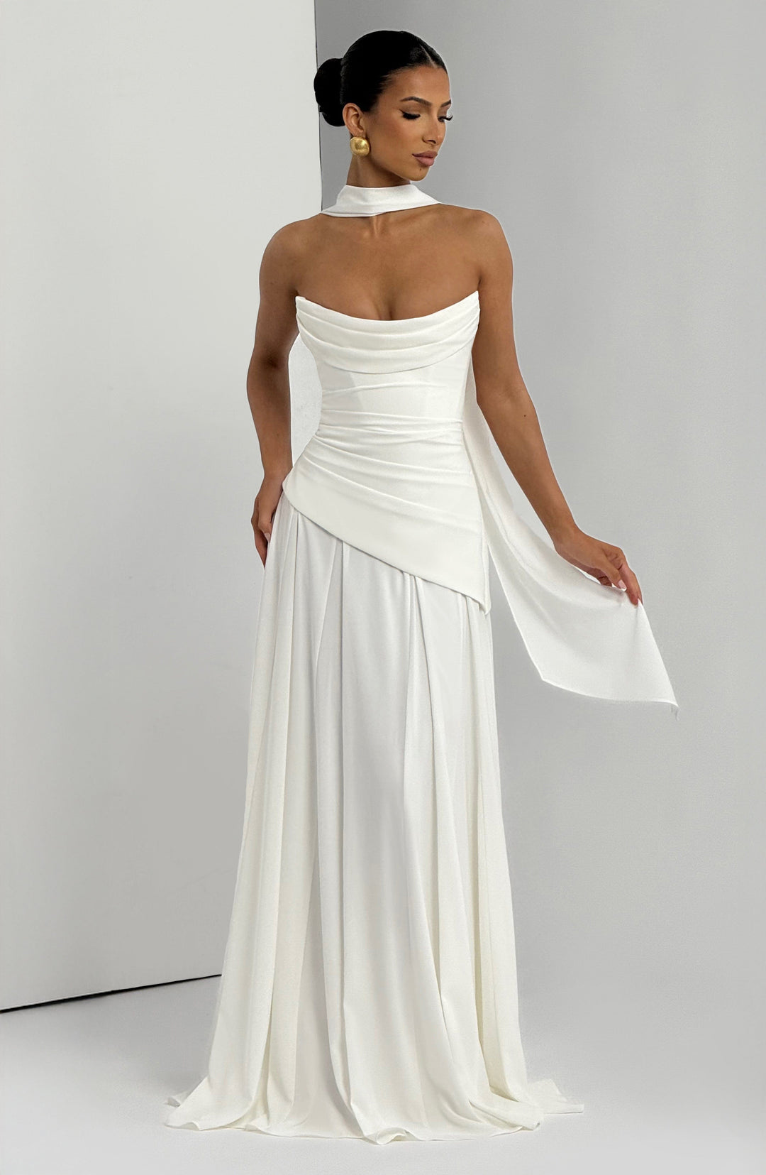 Women white strapless cowl neck maxi dress with flowing draped detail and pleated skirt, front view
