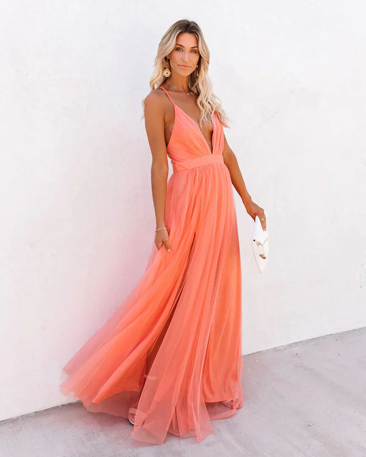 Women peach prom maxi dress with deep V-neck and spaghetti straps, front view