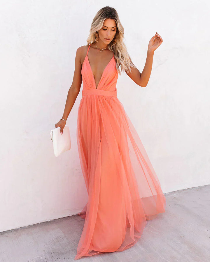 Full body view of women peach prom maxi dress with sheer overlay and front split