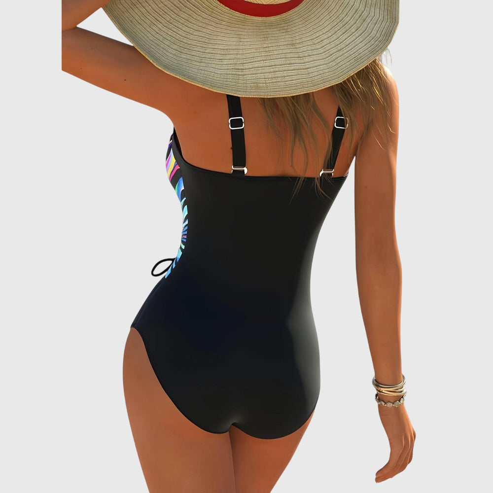 Back view of rainbow striped one-piece swimsuit with black back and adjustable straps