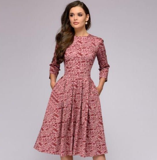 Women pink midi dress with subtle floral print, round neck, three-quarter sleeves, and side pockets.