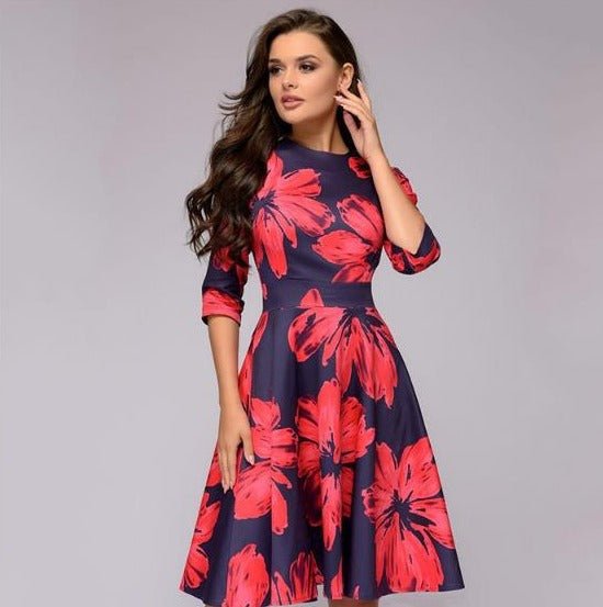 Women navy midi dress with large red floral print, round neck, three-quarter sleeves, and fitted waist.
