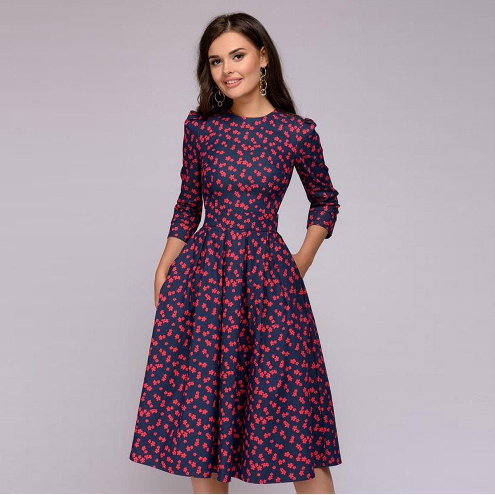 Women navy midi dress with red small floral print, round neck, three-quarter sleeves, and side pockets.